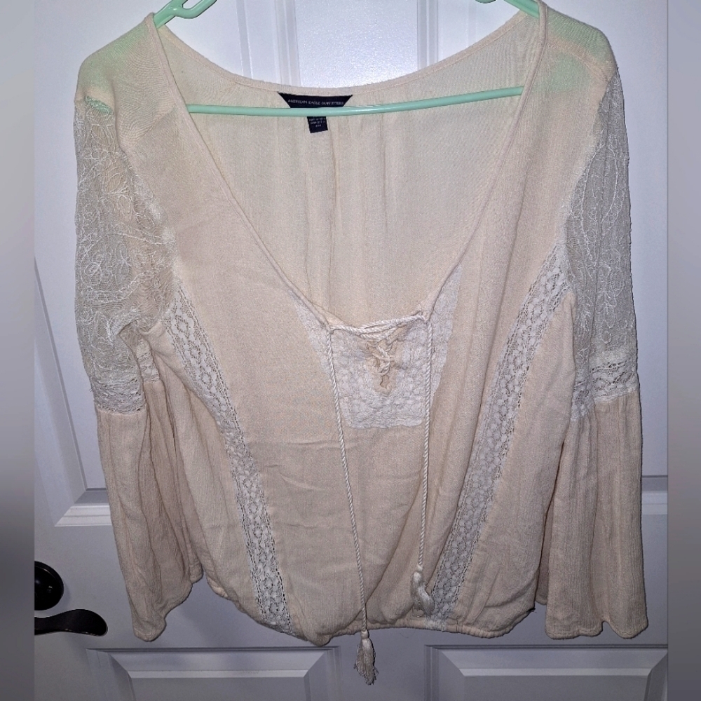 An American Eagle sheer and lace low-cut blouse in a size medium.